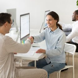 smiling-young-woman-handshaking-satisfied-client-making-deal-office_1163-5131
